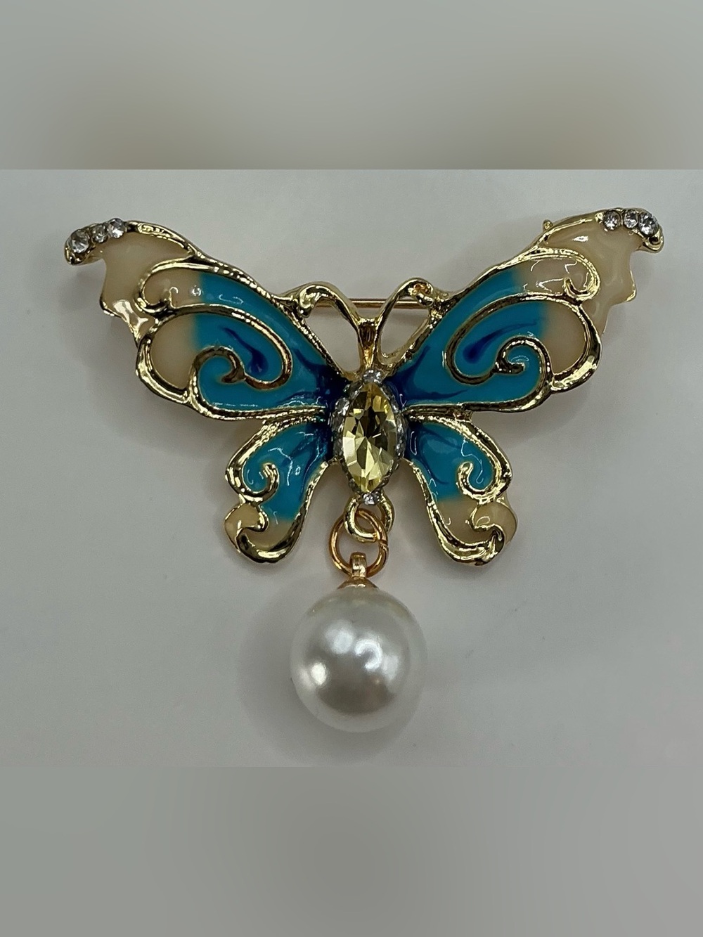 GOLD TONE BLE AND CREAM ENAMEL SMALL BUTTERFLY BROOCH WITH FAUX PEARL ACCENT